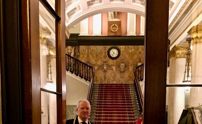 Porter opening main doors to the Clubhouse