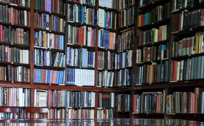 Library shelves reflected on polished dining table